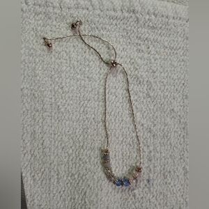 Petite goldtone adjustable blue beaded bracelet